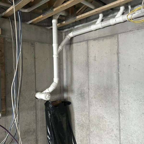 New PVC drain and vent piping in an unfinished basement by KW Plumbing