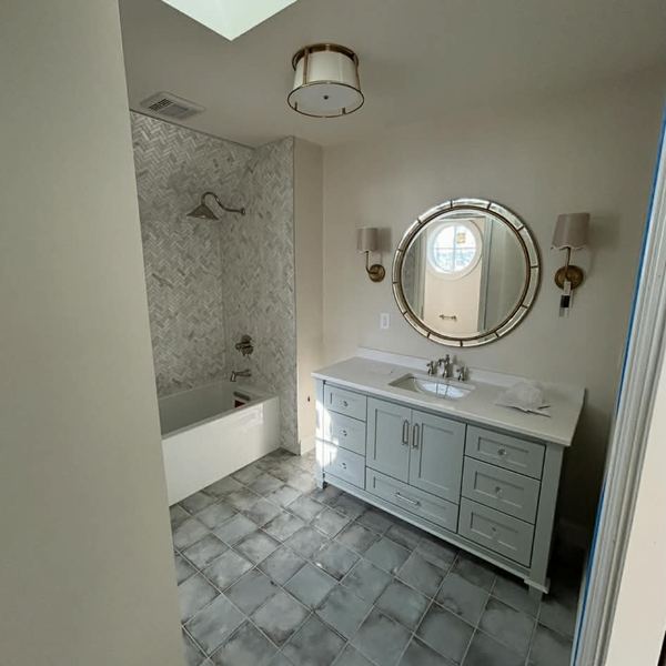 Finished bathroom remodel with vanity and tub by KW Plumbing