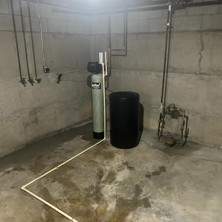 Water softener and brine tank installed in a basement by KW Plumbing